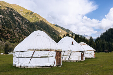 Yurt in Jeti Oguz Valley. National old house of the people of Kyrgyzstan and Asian countries. Yurts on the background of green meadows and highlands. Yurt camp for tourists.