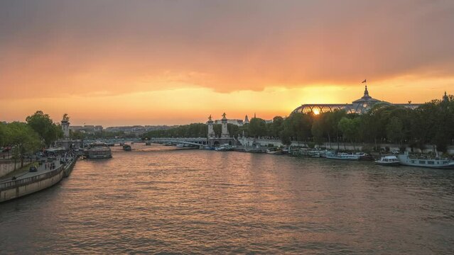 Paris France time lapse 4K, city skyline day to night sunset timelapse at Seine River with Pont Alexandre III bridge and Grand Palais