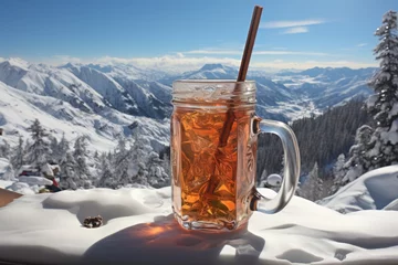 Foto auf Acrylglas Grau A glass of spiced mulled vine with a straw in it. Warm drink in the winter mountains.