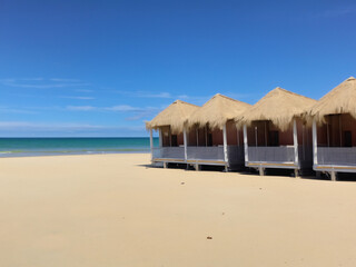 Fototapeta premium Tropical beach with luxury straw beach huts
