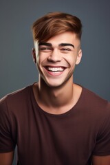 Fototapeta premium shot of a young man smiling while posing in studio
