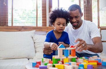 African American father and Little boy hands play blocks in classroom. Learning by playing education group study concept. International pupils do activities brain training in primary school
