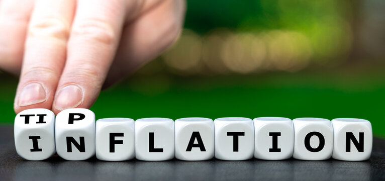 Dice form the words Inflation and Tipflation. Symbol of giving an increasing amount for tips.
