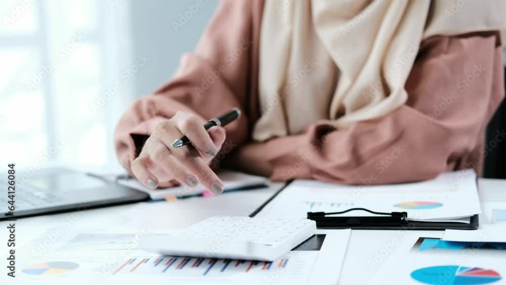 Poster positive muslim accountant clerk in hijab work with papers at desk in modern glass office concentrat