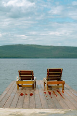 deck chairs on the pier near the lake in the mountains