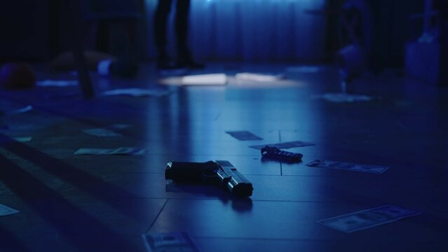 Closeup shot of the floor in the dark room with blue light. Police officer at the back. Crime scene creative concept.