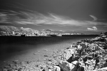 Rocky coastline, natural seashore background in black and white
