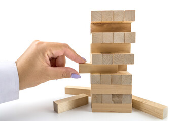 Building from wooden blocks. Wood blocks stack game with Hand on background. Conceptual of Teamwork.
