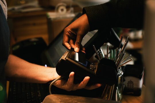 Cropped Image Of Customer Paying Through Credit Card In Store