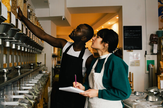 Multiracial colleagues checking inventory in food store