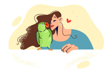 Woman kisses green parrot, rejoicing at presence of beloved pet and enjoying communication with bird
