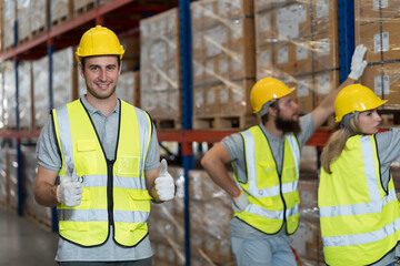 Portrait of male warehouse worker working and wearing safety uniform and helmet at warehouse storage
