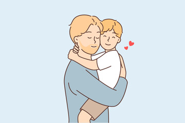 Happy father holds and hugs little son after long separation or returning from vacation