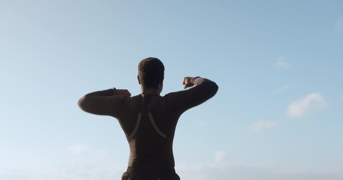 Man, fitness and fist pump on mockup in celebration, winning or sports achievement on sky background. Rear view of excited male person or athlete in success, victory or goals in exercise or workout