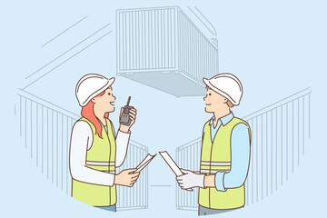 Man and woman work in container port and use walkie-talkie to negotiate with logisticians