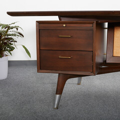 Dark walnut vintage floating top desk. Danish modern furniture. Close-up detail product photograph.