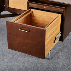 Dark walnut vintage floating top desk. Danish modern furniture. Close-up detail product photograph.