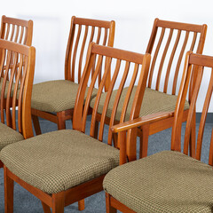 Set of Mid-Century Modern tweed upholstered dining chairs. Vintage teak furniture. Interior photograph.