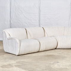 Vintage 1980s white sectional sofa. Textured upholstery furniture. Interior product photograph.