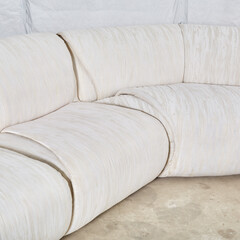 Vintage 1980s white sectional sofa. Textured upholstery furniture. Close-up photograph.