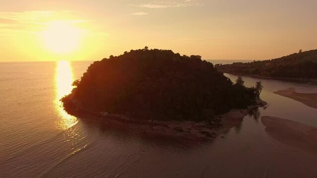 .aerial view the sun above Kala island at Layan beach Phuket..colorful yellow sky of sunset at horizon.Phuket beach sea Amazing beach, .Beautiful beach Phuket Thailand, Nature and travel concept..