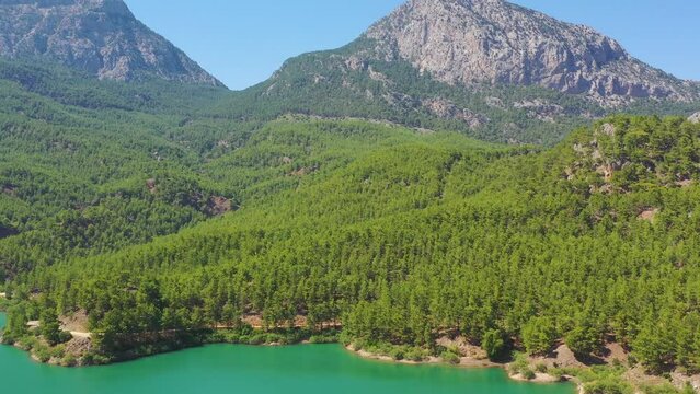 Aerial top panoramic panorama view of National Park Turkey. Wooden turquoise lake reservoir forest among rocky mountains and peaks