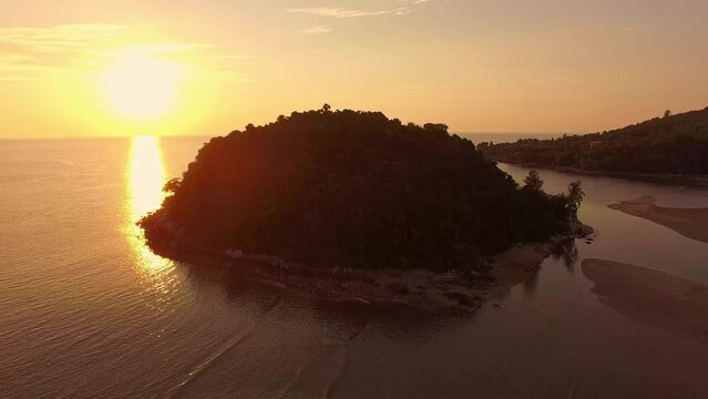 .aerial view the sun above Kala island at Layan beach Phuket..colorful yellow sky of sunset at horizon.Phuket beach sea Amazing beach, .Beautiful beach Phuket Thailand, Nature and travel concept..