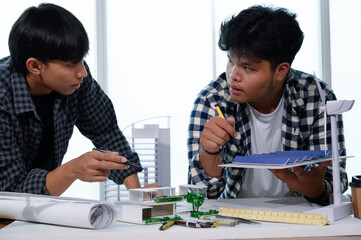 Asian Architect Students Studying Modern House Design and Finding Ways to Utilize Natural Alternative Energy or Use Natural Renewable Energy, Concepts of Eco-Friendly Living for a Sustainable Future.