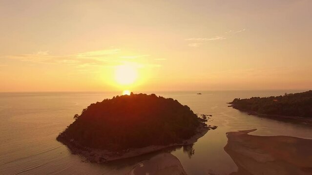 .aerial view the sun above Kala island at Layan beach Phuket..colorful yellow sky of sunset at horizon.Phuket beach sea Amazing beach, .Beautiful beach Phuket Thailand, Nature and travel concept..