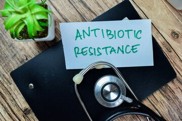 Concept of Antibiotic Resistance write on sticky notes isolated on Wooden Table.