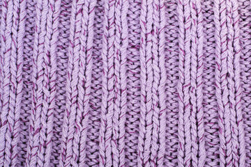 Sweater or scarf fabric texture large knitting. Knitted jersey background with a relief pattern. Braids in knitting . Wool hand- machine, handmade