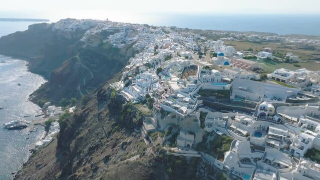 Santorini's iconic blue roofs shine in the sun.