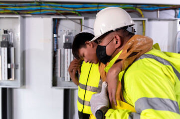 First Aid Factory Team, Support allows patient, Life-saving and rescue methods. Accident at work of electrician job or Maintenance worker in the control room of factory.