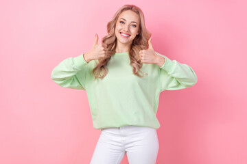 Photo of optimistic girl showing thumb up symbol good job cool recommendation double feedback sale outfit isolated on pink color background