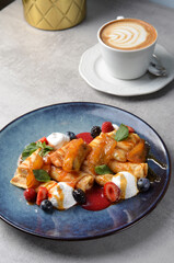 Crepes with Fresh Berries, Caramelized Bananas and Toppings, Thin Pancakes on a Plate