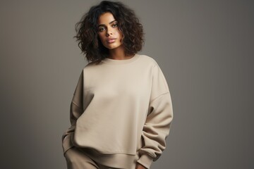 Fototapeta premium Portrait of a Fictional Model Wearing a Large Oversized Plain Sweatshirt Isolated on a Colored Blank Background. Generative AI.