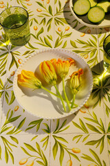 Raw stuffed with provolone cheese zucchini flowers, squash blossoms on colorful background. Italian cuisine concept. Vertical