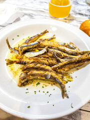 Anchovies cooked Basque Country style on a restaurant table.