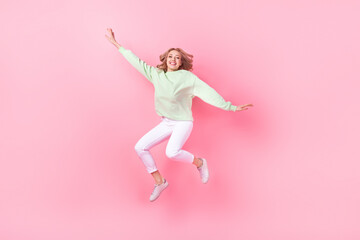 Fototapeta na wymiar Full size photo of overjoyed nice girl jumping flying have good mood isolated on pink color background