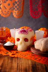 Sugar skull with Candles, Cempasuchil flowers or Marigold and Papel Picado. Decoration traditionally used in altars for the celebration of the day of the dead in Mexico