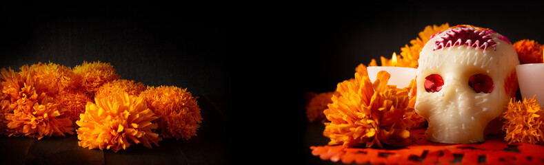Sugar skull with Cempasuchil flowers or Marigold and Papel Picado. Decoration traditionally used in altars for the celebration of the day of the dead in Mexico