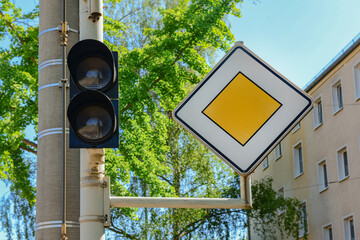View of traffic lights with road sign in city, closeup
