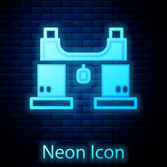 Glowing neon Binoculars icon isolated on brick wall background. Find software sign. Spy equipment symbol. Vector