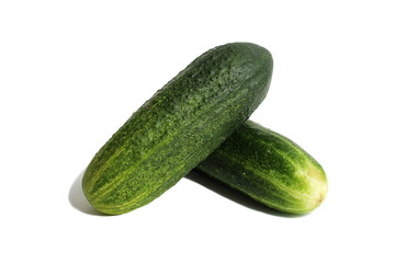 Two fresh green cucumbers lie on a white background.