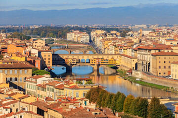 Fototapeta na wymiar Panoramic view of medieval stone bridge Ponte Vecchio over Arno river in Florence, Tuscany, Italy. View from Michelangelo Hill