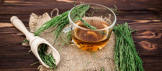 cup of tea from horsetail, made from fresh potion, from pharmacy mortar. Horsetail infusions are used as a diuretic