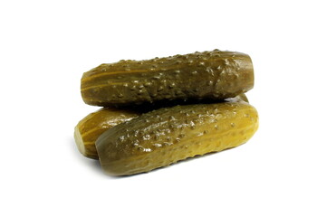 Three pickled cucumbers lie on a white background.