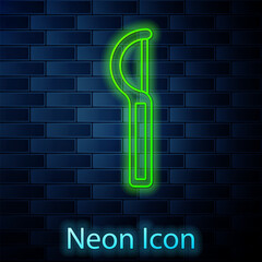 Glowing neon line Dental floss icon isolated on brick wall background. Vector