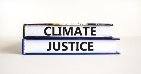 Climate justice symbol. Concept words Climate justice on beautiful books. Beautiful white table white background. Business environment climate justice concept. Copy space.
