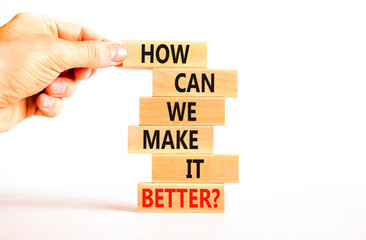 We make it better symbol. Concept words How can we make it better on wooden block. Beautiful white table white background. Businessman hand. Business we make it better concept. Copy space.